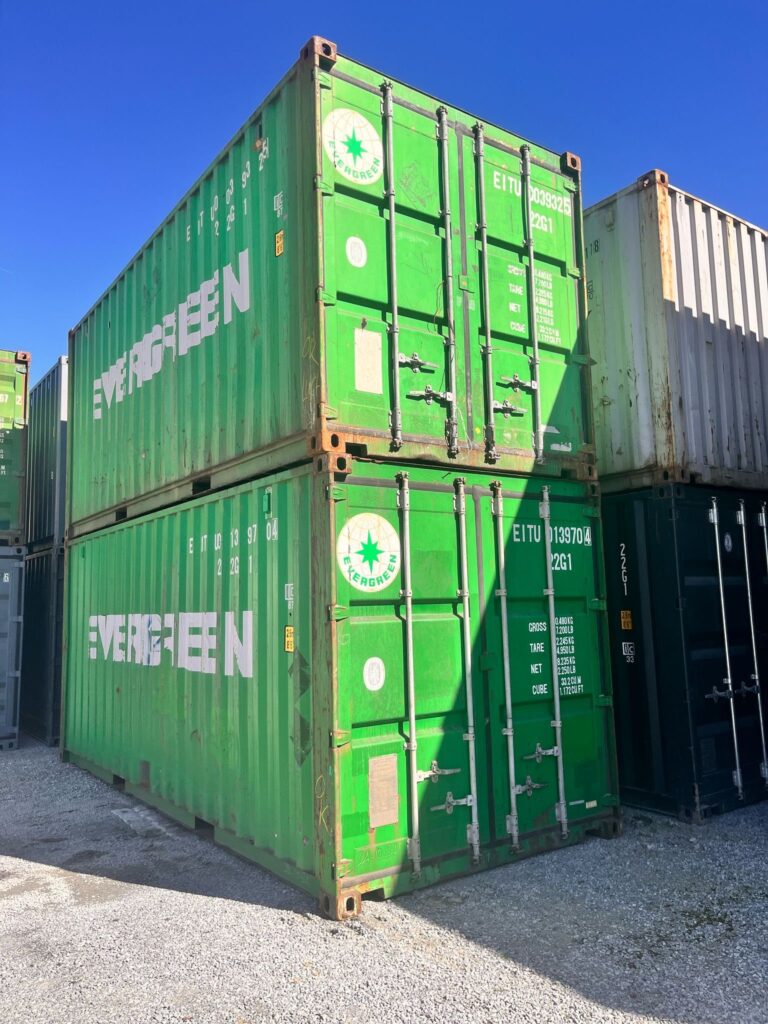 Zwei grüne 20-Fuß-Container der A-Variante übereinander gestapelt, Blick auf Tür- und Längsseite